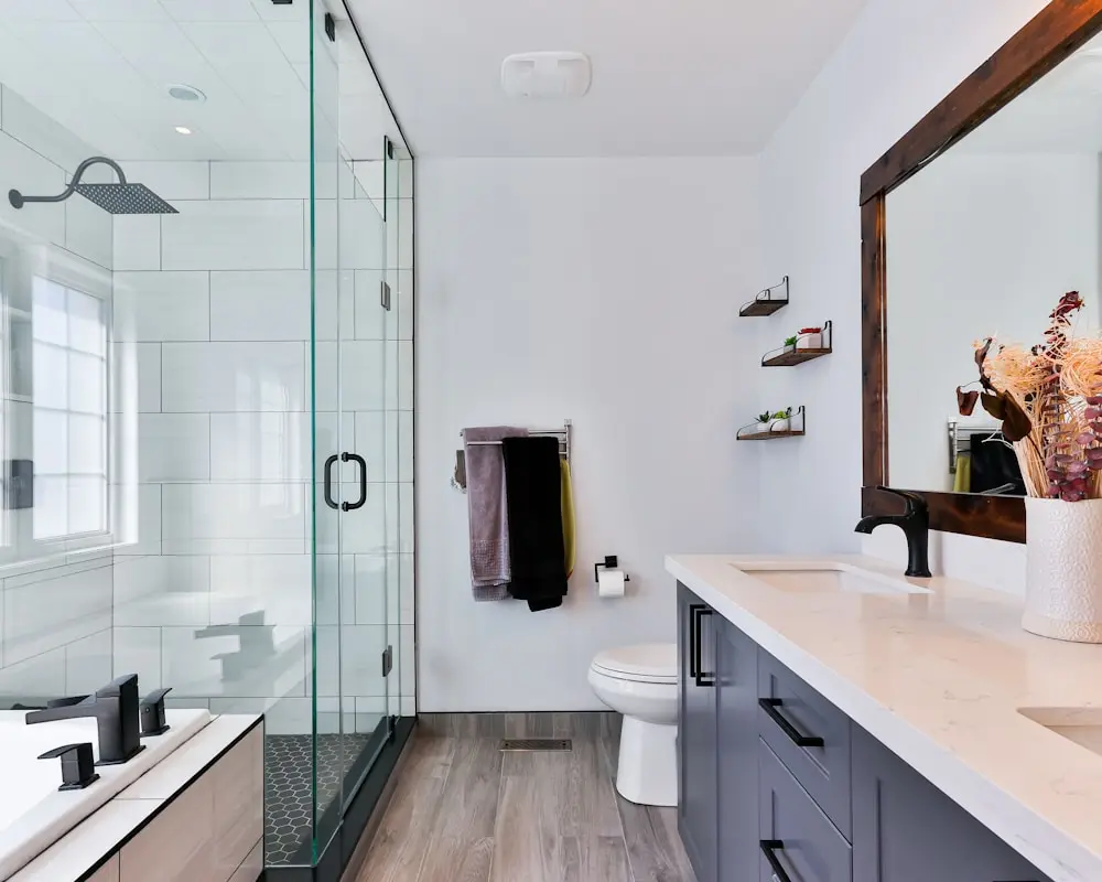 Finished bathroom remodel with a glass shower and a new double vanity
