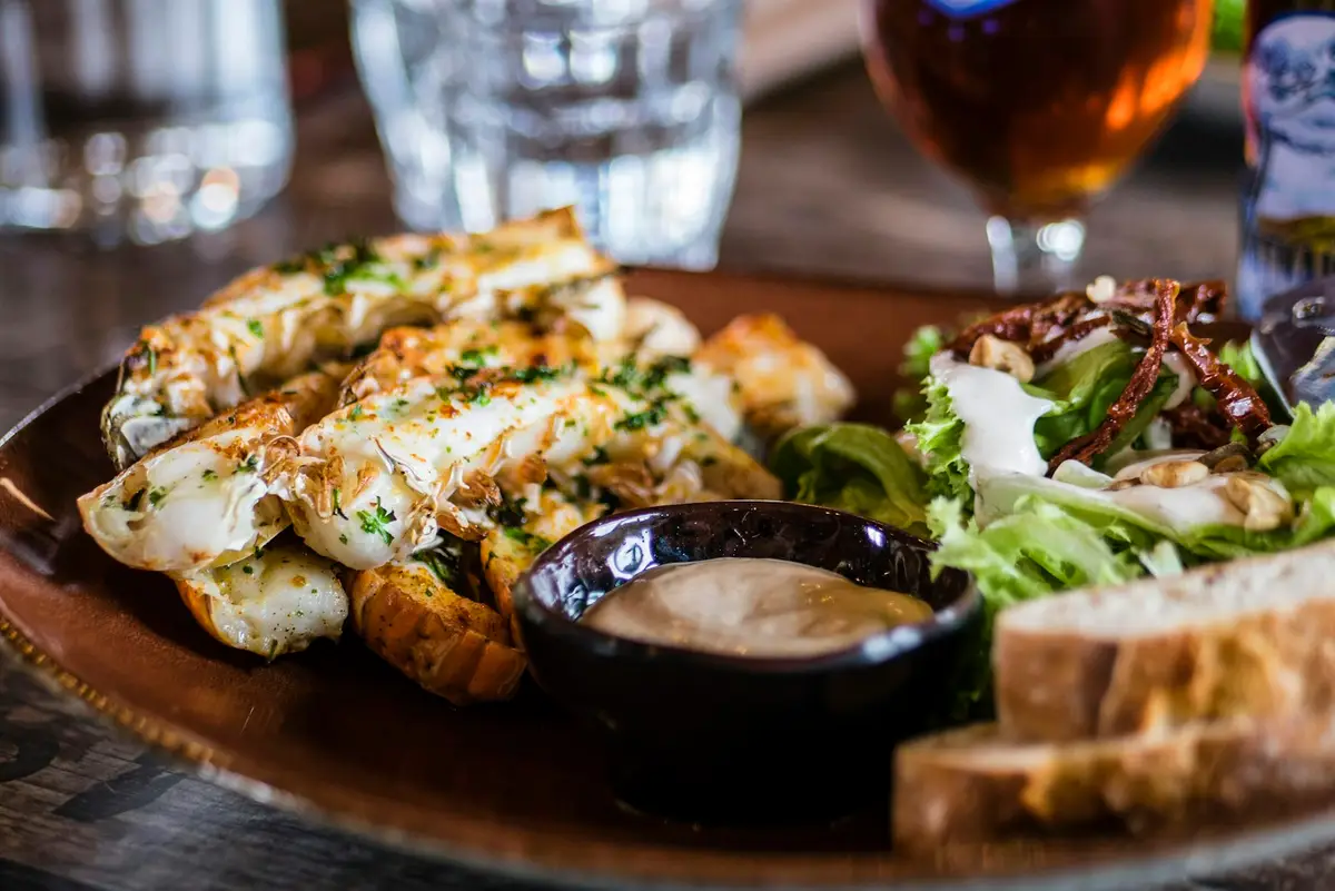 A hearth-fired plate of grilled fish with dressed greens and sourdough